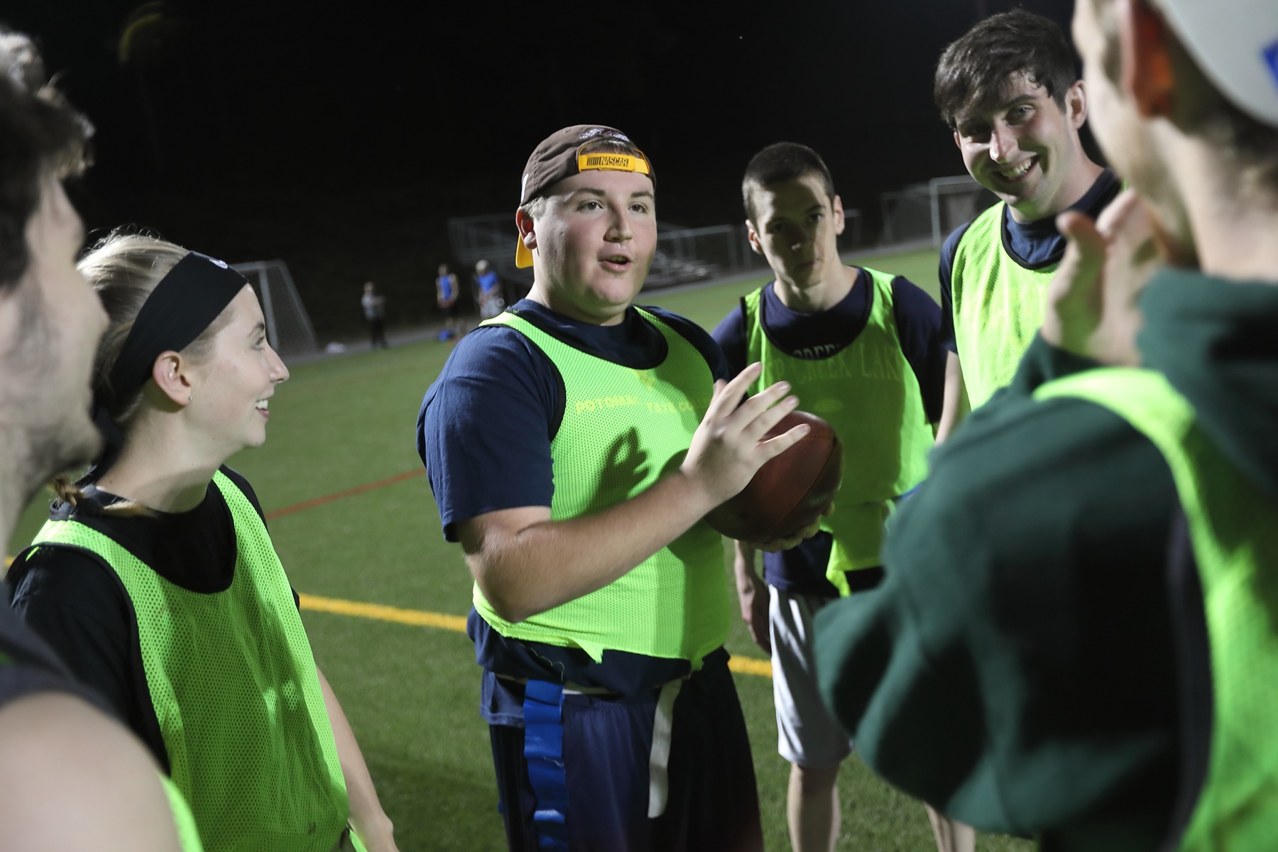 Students conversing on the turf field during a flag football game at WVU Potomac State College